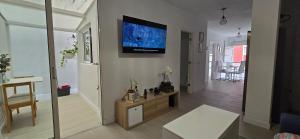a living room with a flat screen tv on the wall at PisoYari in Santa Cruz de la Palma
