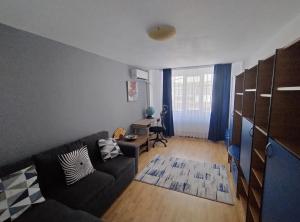 a living room with a couch and a table at Apartament Roman in Roman