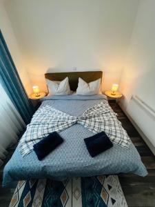 a bedroom with a bed with a bow tie on it at Apartment Aleja in Sarajevo