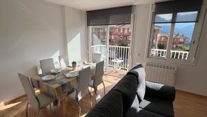 a living room with a table and a couch at Apartament acollidor al Berguedà 6p in Sant Jordi de Cercs