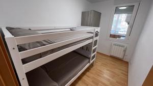 a white bunk bed in a room with a window at Apartament acollidor al Berguedà 6p in Sant Jordi de Cercs +41 photos