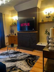 a living room with a television on top of a fireplace at Prettide Suite Two-1 free Parking in Gillingham +13 photos