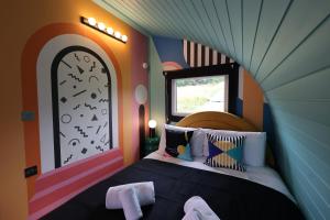 a bedroom with a bed in a room with a window at Ammonite Glamping Pod & Hot Tub in Hungerton