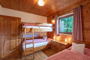 a bedroom with two bunk beds in a cabin at Ferienhaus Soregina in Ellmau
