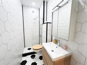 a white bathroom with a toilet and a sink at Perfect Long-term Stay Stylish and Spacious Top Center Next to Vitosha Blvd in Sofia