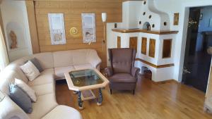 a living room with a couch and a chair at Apartments Almstein in Abtenau