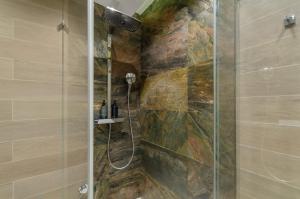a bathroom with a shower with a glass at Modern new cozy apartment Kvartet Railway Station in Kyiv +98 photos