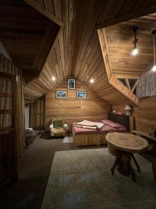 a bedroom with a bed and a table in a room at Hermit Retreat in Darjeeling