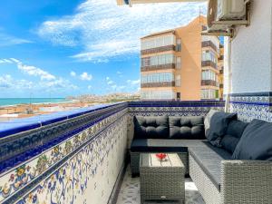 a balcony with a couch and a view of the beach at Sea View La Mata Apartment in La Mata