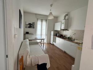 a kitchen with a couch and a table in a room at Room Saronno + B&B in Saronno