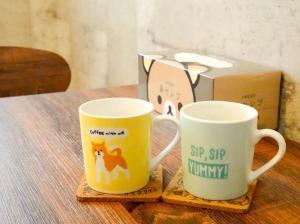two coffee mugs sitting on a table with a box at F HOUSE Os Residence S3 in Osaka