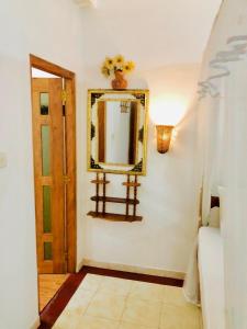 a hallway with a mirror on the wall at Castle Bay Resort in Weligama +89 photos