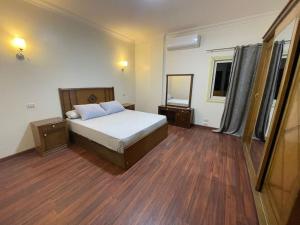 a bedroom with a bed and a mirror in it at luxuries Apt in new Cairo in Cairo +13 photos