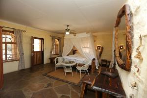 a bedroom with a bed and a table and chairs at Düsternbrook Guest Farm in Dusternbrook