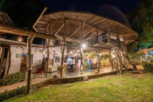 an outside view of a house at night at Hostal La Media Luna Palomino in Palomino