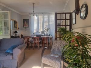a living room with a couch and a table at L'AnciennePoste in Bugeat