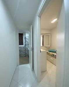 an open door to a bathroom in a house at Casa Plumeria in Marinella di Selinunte