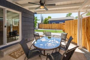a patio with a glass table and chairs at Main Street Retreat in Roseville