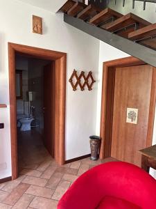 a red chair in a room with a bathroom at Ca' Rivella - paceful country living in Villa dʼAiano +24 photos