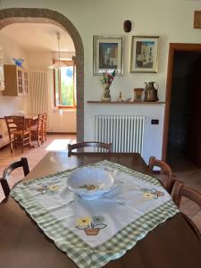 a table with a bowl on top of it in a kitchen at Ca' Rivella - paceful country living in Villa dʼAiano
