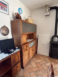 a room with a desk with a computer and a refrigerator at Ca' Rivella - paceful country living in Villa dʼAiano