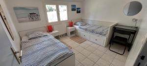 En eller flere senge i et værelse på Kali'Na