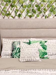 a bed with two pillows and a head board at Apaisante Tropical Lodge in Tagaytay