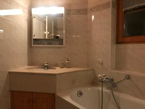 a bathroom with a sink and a bath tub at Villars SWISS Alpes in Villars-sur-Ollon +19 photos