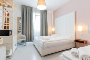 Postel nebo postele na pokoji v ubytování Hotel Regina