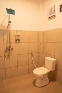 a bathroom with a toilet and a shower at Fantasticroom Labuan Bajo in Labuan Bajo +32 photos