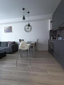 a kitchen and dining room with a table and chairs at Bruklinas in Šiauliai