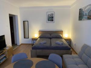 a bedroom with a bed and a couch at Mini Premium in Miskolc
