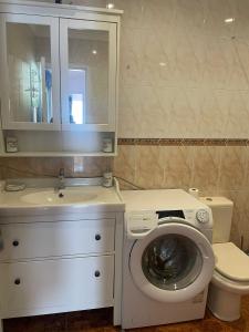 a bathroom with a washing machine and a sink at San juan 2 bedrooms 27 in Playa de San Juan