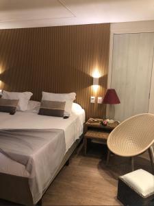 a bedroom with a bed and a table and a chair at Fortaleza 703--Fortaleza 713 in Fortaleza +16 photos