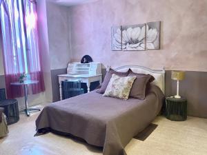 a bedroom with a bed and a piano at Les Lauriers centre ville avec jardin in Nyons +53 photos