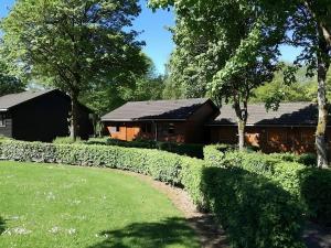 a house with a fence and a yard at La Boverie, chalet 216 in Rendeux