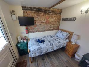 a small bedroom with a bed and a tv at Salisbury Guest House - free parking in York