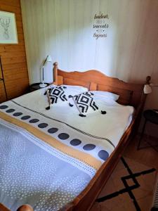 a bedroom with a bed with a wooden headboard at La Boverie, chalet 216 in Rendeux