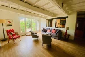 a living room with a couch and some chairs at Charming house near Ile de Ré with terrace in Nieul-sur-Mer