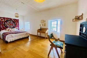 a bedroom with a bed and a desk and a chair at Charming house near Ile de Ré with terrace in Nieul-sur-Mer