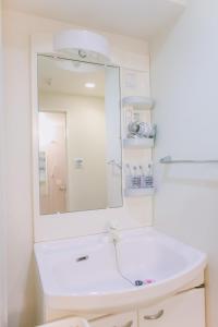 东京Ikebukuro Center! Ikebukuro 6min walk! 池袋中心地带! 池袋车站步行6分! 公寓干湿分离! 智能马桶! 高速无限制网路!Autolock302的带白色水槽和镜子的浴室 更多11张照片