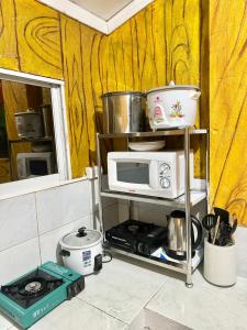 a microwave sitting on a shelf in a kitchen at Hotel California in Boracay