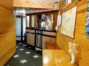 a room with a table and a wooden wall at Zodiac House in Samokov