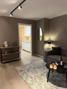 a living room with a couch and a table at Apartment in Tromsø - Close to everything - Free parking in Tromsø