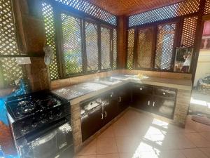 a kitchen with a stove and some windows at Ocean Breeze Inn in Boracay
