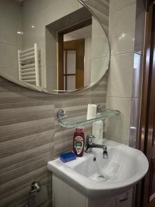 a bathroom with a sink and a mirror at Small price in Chişinău