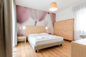 Postel nebo postele na pokoji v ubytování Hotel Regina