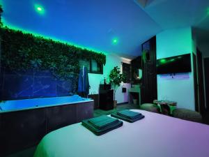 a bedroom with a white bed with a blue light at La Jungle Room in Rognac +3 photos