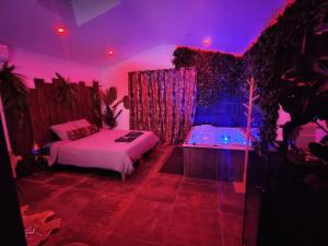 a bedroom with two beds and a purple lighting at La Jungle Room in Rognac