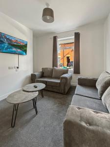 un salon avec un canapé et une table dans l'établissement Amaya One -3 bedroom townhouse - with garden - close to town centre - sleeps 7, à Grantham